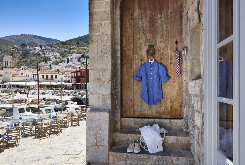 MyHydra Concept Store — shirt on wooden door, Hydra port view