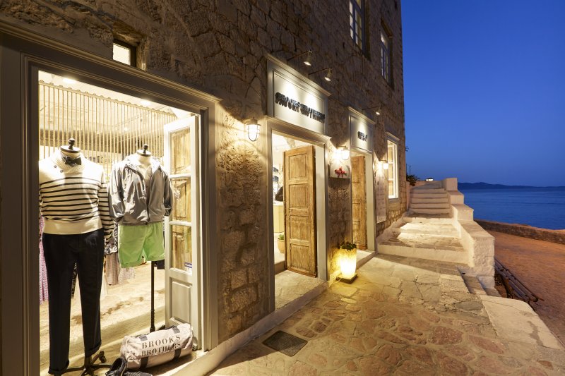 MyHydra Concept Store — illuminated storefront at dusk, mannequins in window
